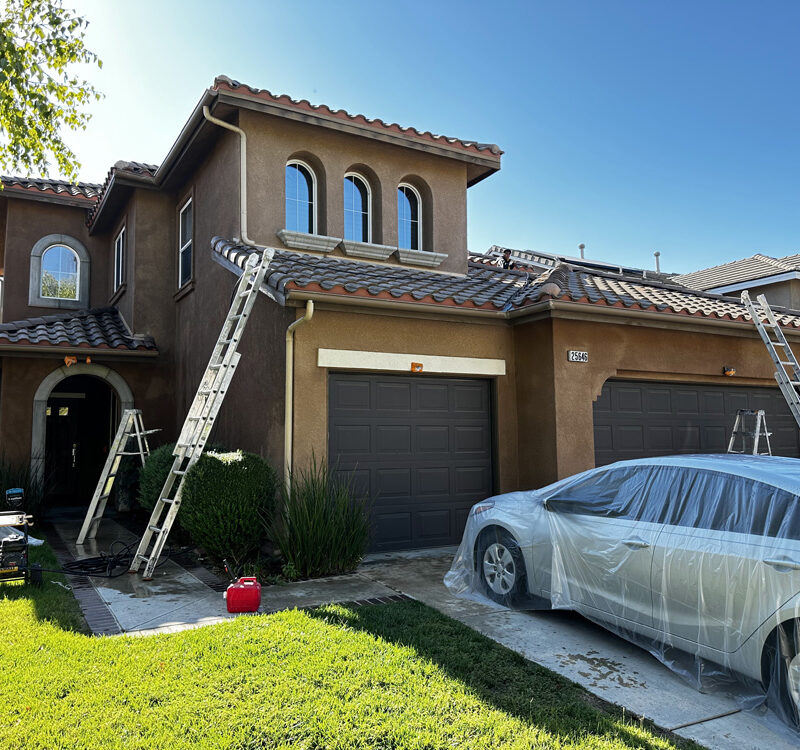 in process of exterior painting of brown home near santa clarita